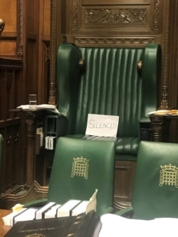 A piece of paper with the word "silenced" sits on the British Parliament speaker's chair at the House of Commons, in protest of the House's suspension, in London, Sept. 10, 2019.