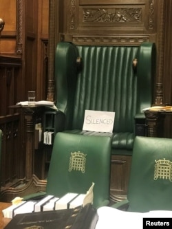 A piece of paper with the word "silenced" sits on the British Parliament speaker's chair at the House of Commons, in protest of the House's suspension, in London, Sept. 10, 2019.