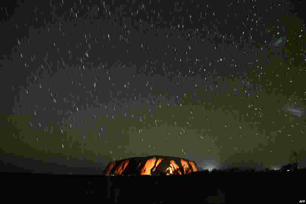 Stars trails are seen over Uluru, also known as Ayers rock, after a permanent ban on climbing the monolith at the Uluru-Kata Tjuta National Park in Australia&#39;s Northern Territory, Oct. 26, 2019, to meet the wishes of Aboriginal people.