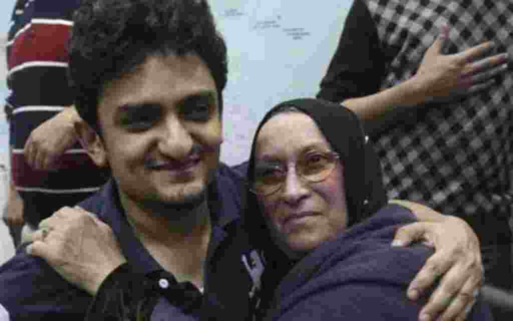 Egyptian Wael Ghonim, a Google Inc. marketing manager, who has become a hero of the demonstrators since he went missing on Jan. 27, two days after the protests began, hugs the mother of Khaled Said, a young 28-year-old businessman who died in June, 2010, 