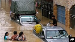 Residents wade through flood waters in down town Hat Yai of Songkhla province, southern Thailand (2010 File)