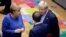 FILE - British Prime Minister Boris Johnson, right, speaks with German Chancellor Angela Merkel, left, and French President Emmanuel Macron during an EU summit in Brussels, Belgium, Oct. 17, 2019.