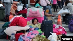 FILE - Venezuelan children sleep at the Binational Border Service Center in Tumbes, Peru, after a new migration law was imposed for all Venezuelan migrants to have valid visas and passports, June 15, 2019. 