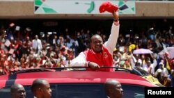 Kenya's President Uhuru Kenyatta waves to supporters as he arrives at the Kasarani stadium for the official launch of the Jubilee Party ahead of the 2017 general elections in Kenya's capital Nairobi, Sept. 10, 2016.