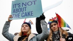 Lydia Macy, 17, left, and Mira Gottlieb, 16, both of Berkeley, Calif., rally outside of the Supreme Court, which is hearing the Masterpiece Cakeshop v. Colorado Civil Rights Commission, Dec. 5, 2017, in Washington.