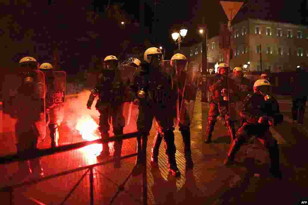 Riot police are attacked with flares during clashes in front of the Greek parliament on February 19, 2012. (AP)