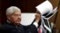 FILE - Former Senator Bob Graham (D-FL) displays 28 pages that are still classified and blacked out, of a U.S. government report on who financed the 9/11 attacks on the United States, at a news conference on Capitol Hill, July 5, 2015.