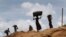 FILE - Rohingya girls carry firewood on their heads as they make their way through Kutupalong refugee camp, June 28, 2018, in Bangladesh.