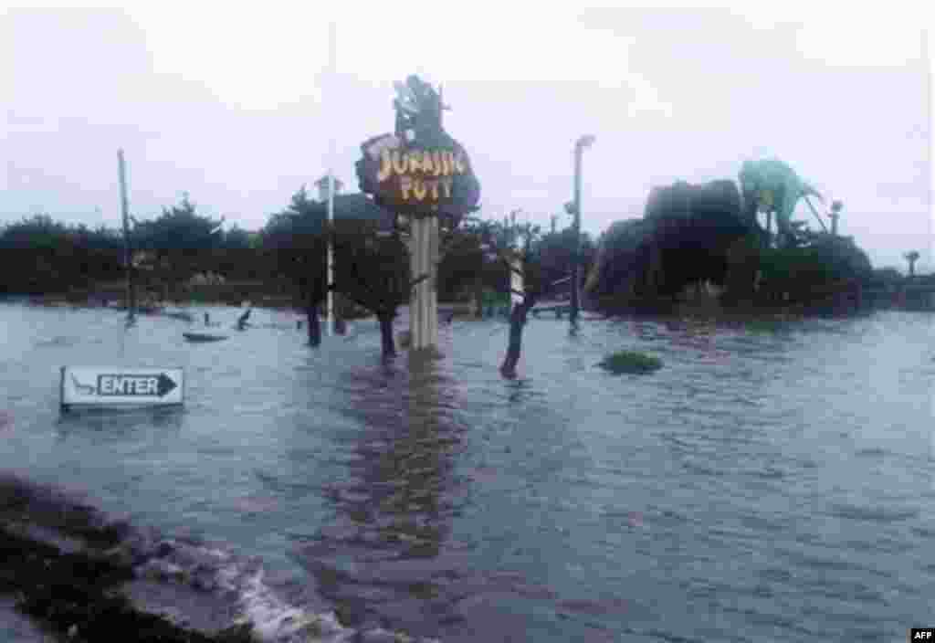 Floodwaters from the Albemarle Sound rise over a mini golf course at dusk on the Outer Banks in Nags Head, N.C., Saturday, Aug. 27, 2011 as Hurricane Irene leaves the North Carolina coast. Irene knocked out power and piers in North Carolina, clobbered Vir