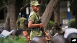 FILE - Tanzanian police stand guard in Dar es Salaam, Tanzania, Oct. 28, 2015. 
