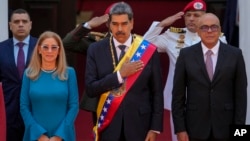 Venezuelan President Nicolas Maduro, center, stands with his wife, Cilia Flores, left, and National Assembly President Jorge Rodriguez after his swearing-in for a third term at the National Assembly in Caracas, Venezuela, Jan. 10, 2025.