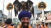 A Sikh devotee with an eagle takes part in a religious procession on the eve of the birth anniversary of the fourth Sikh Guru Ramdas in Amritsar on Oct. 18, 2024.