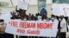 Supporters of Tanzania's opposition party Chadema leader Mbowe holding a banner chant slogans, in Dar Es Salaam, Aug 5, 2021.