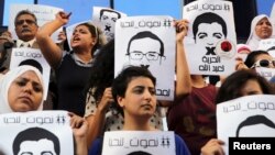 FILE - Protesters rally in support of three detained Al Jazeera journalists in front of the Press Syndicate in Cairo, Egypt, June 1, 2014.