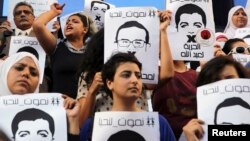 FILE - Protesters rally in support of three detained Al Jazeera journalists in front of the Press Syndicate in Cairo, Egypt, June 1, 2014.