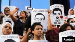 FILE - Protesters rally in support of three detained Al Jazeera journalists in front of the Press Syndicate in Cairo, Egypt, June 1, 2014.