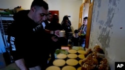 FILE—Volunteers distribute food at an abandoned hotel in the southern Lebanon town of Marwanieh on March 15, 2024.