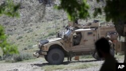 FILE - U.S. forces and Afghan commandos are seen in Asad Khil village in the Achin district of Jalalabad, Nangarhar province, Afghanistan, April 17, 2017. Iran accuses the United States of aiding Islamic State in Afghanistn, charges Washington vehemently denies.