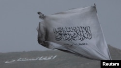 FILE - The Taliban's flag is seen in a marketplace in Kabul, Afghanistan, May 10, 2022. While the Taliban are the de facto rulers of Afghanistan, no nation has officially recognized the group as the country's true government.