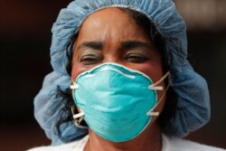 Provident Hospital of Cook County nurse Kate Ikenyi participates in an end of shift demonstration, April 6, 2020, in Chicago's Hyde Park neighborhood.