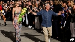 Gigi Hadid, left, and Tommy Hilfiger walk the runway at the Tommy Hilfiger TommyxGigi Runway Show at Venice Beach on Feb. 8, 2017 in Los Angeles.