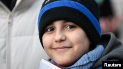 Hassan Al-Khalaf, 11, who escaped Ukraine on his own to join his brother studying in Slovakia, attends an anti-war rally, following Russia's invasion of Ukraine, in Bratislava, Slovakia, March 11, 2022.