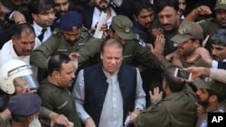 FILE - Pakistani former Prime Minister Nawaz Sharif arrives at a court in Lahore, Oct. 11, 2019.