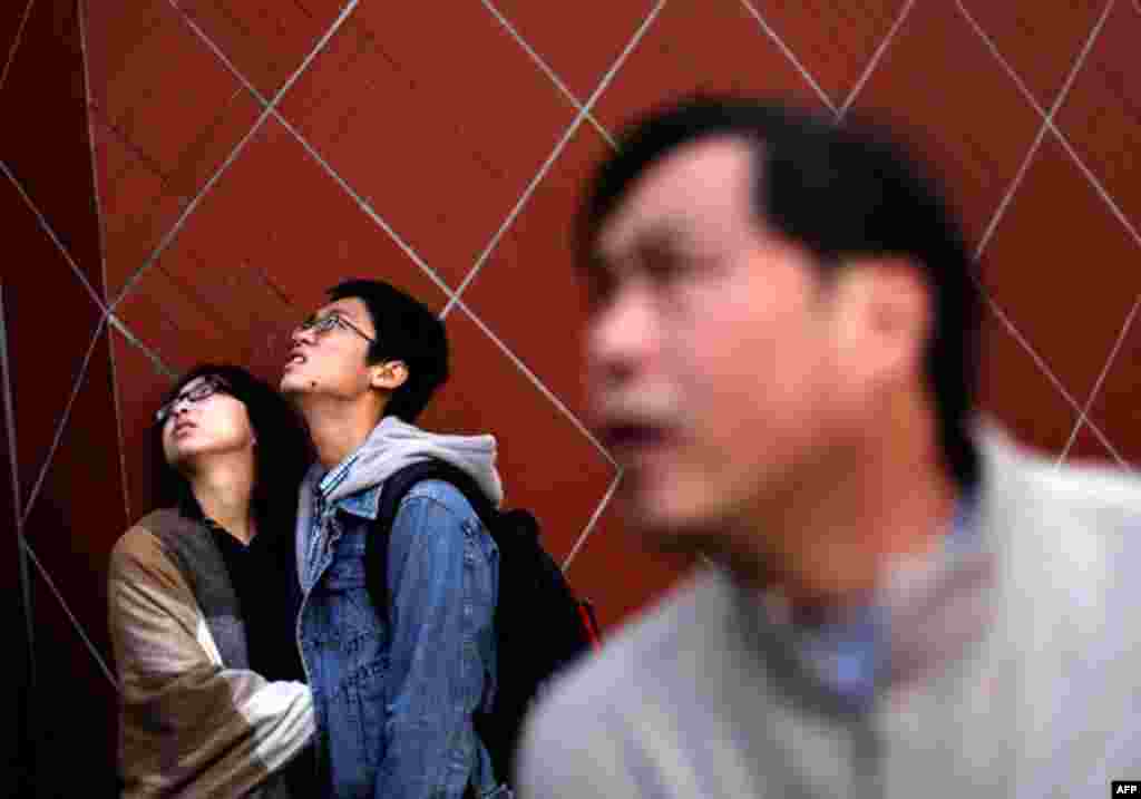 Nov. 18: People react as they look at the entrance of a burnt apartment block in Shanghai. Lax supervision was the cause of a fire that killed 53 people in a Shanghai apartment building this week. (Aly Song/Reuters)