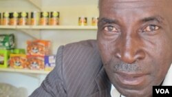 John Stheole has owned his spaza shop for more than a decade in Dube Village, Soweto, South Africa. (Photo Gillian Parker for VOA)