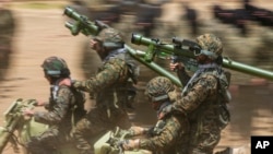 FILE - Fighters from the Lebanese militant group Hezbollah train in southern Lebanon.
