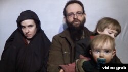 In this still image taken from a December 2016 video released by the Afghan Taliban, U.S. national Caitlan Coleman and her Canadian husband, Joshua Boyle read a statement urging then-President-elect Donald Trump to negotiate to secure their release.