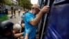 Volunteers assist a man to enter an evacuation train as Russian forces advance across the frontlines in the Donetsk region, at the train station in Pokrovsk, Ukraine, on Aug. 2, 2024.