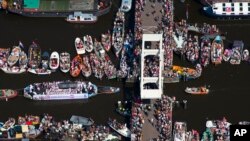 People celebrate the annual Canal Parade during the Gay Pride in Amsterdam, Netherlands, Saturday, Aug. 6, 2016. 