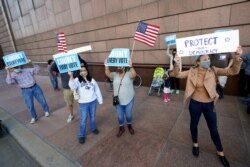 Demonstrators stand across the street from the federal courthouse in Houston, Texas, November 2, 2020, before a hearing in federal court involving drive-thru ballots cast in Harris County.