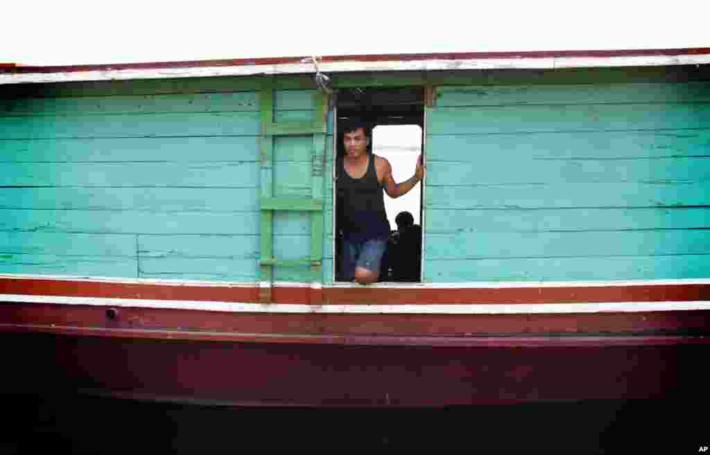 A Lao boatman, Porn, was robbed by pirates in March on the way to China. (VOA - D. Schearf)