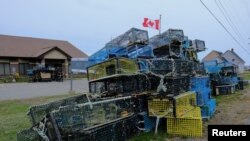 Lobster traps belonging to fishermen of the Sipekne'katik band, which were seized in protest by non-native fishers, lie dumped outside the federal Department of Fisheries and Oceans (DFO) office in Meteghan, Nova Scotia, Canada, Sept. 22, 2020. 
