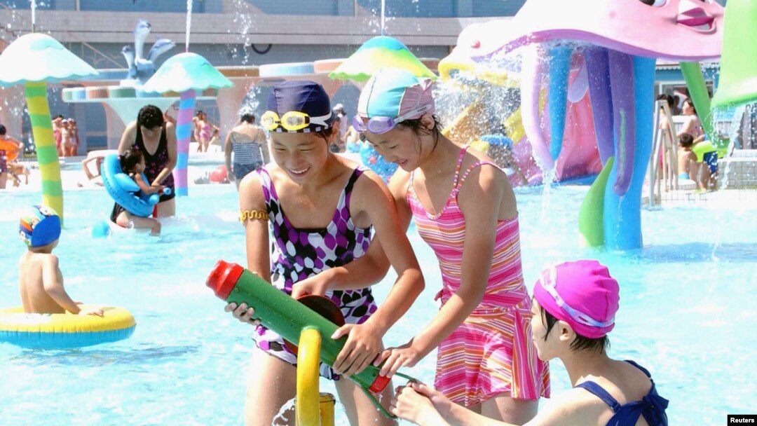 FILE - Visitors cool off at Munsu Water Park east of Pyongyang, North Korea — a project in which wealthy individuals known as Donju are said to have played a key role.