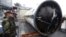 A South Korean sailor stands guard near a part of debris from a rocket launched by North Korea on a ship at navy's 2nd Fleet headquarters in Pyeongtaek, South Korea, Friday, Dec. 14, 2102.