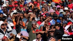 Supporters of South Africa's Economic Freedom Fighters (EFF) listen to their leader Julius Malema during his campaign, ahead of the August 3 local government elections, in Etwatwa, a township near Benoni, South Africa, July 27, 2016. 