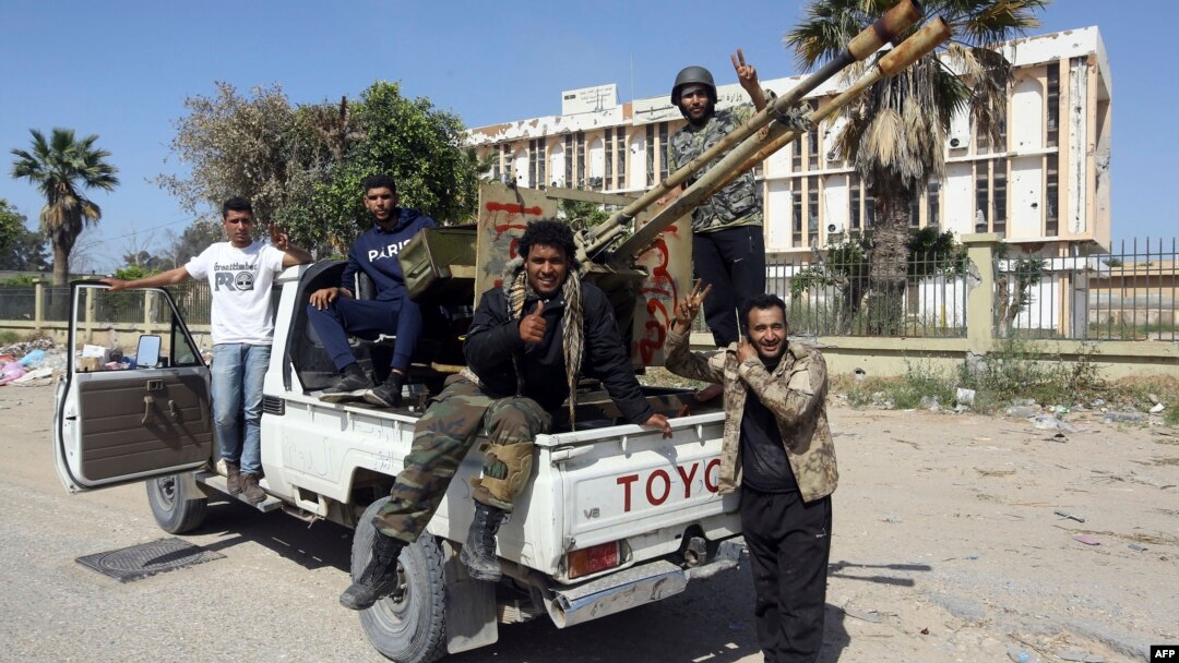 Forces loyal to Libya's Government of National Accord gesture, April 18, 2019, after taking control of the area of al-Aziziyah, located about 40 kilometers south of the Libyan capital Tripoli, following fierce clashes with forces loyal to strongman Khalifa Haftar.