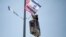 A worker hangs Israeli and American flags on a lamppost along a freeway leading to Jerusalem, days before a planned visit by President Donald Trump, May 16, 2017. 