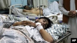 Afghans lie on beds at a hospital after they were wounded in the deadly attacks outside the airport in Kabul, Afghanistan, Thursday, Aug. 26, 2021. Two suicide bombers and gunmen attacked crowds of Afghans flocking to Kabul's airport Thursday,…
