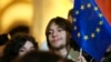 FILE - A young man holds an EU flag as he attends an opposition protest against the results of the parliamentary election in Tbilisi, Georgia, on Oct. 28, 2024.