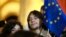 FILE - A young man holds an EU flag as he attends an opposition protest against the results of the parliamentary election in Tbilisi, Georgia, on Oct. 28, 2024.