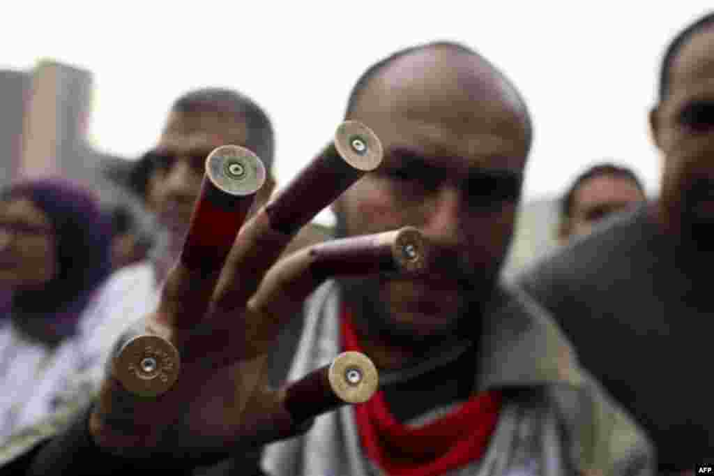 An anti-government protester displays spent shotgun cartridges in Tahrir, or Liberation Square in Cairo, Egypt, Tuesday, Feb. 1, 2011. More than a quarter-million people flooded into the heart of Cairo Tuesday, filling the city's main square in by far the