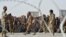 FILE - People wait to cross into Afghanistan at the Pakistani border post Chaman, Sept. 1, 2016.