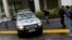 FILE- A vehicle belonging to the Brazilian Federal Revenue Authority leaves the headquarters of Brazilian conglomerate Camargo Correa during "Operation Carwash" in Sao Paulo, Nov. 14, 2014. Fifteen search warrants in the "Operation Carwash” probe were issued Wednesday. 