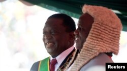 Zimbabwe's President Emmerson Mnangagwa is congratulated by the Chief Justice, Luke Malaba, after taking the oath of office during his presidential inauguration ceremony in Harare, Aug. 26, 2018. 