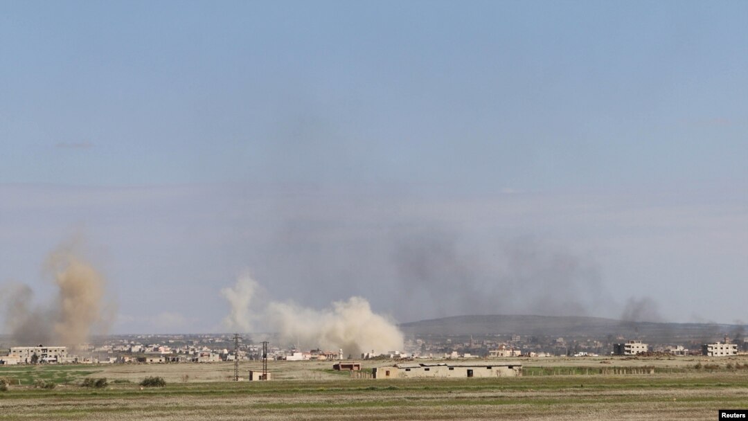 Smoke rises around the Syrian southern town of Bosra al-Sham, March 24, 2015. 