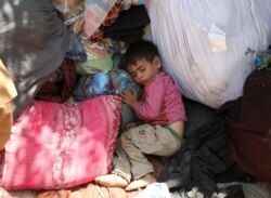 An internally displaced child from northern provinces, who fled from his home due the fighting between Taliban and Afghan security forces, sleeps in a public park that they use as shelter in Kabul, Afghanistan, Aug. 10, 2021.